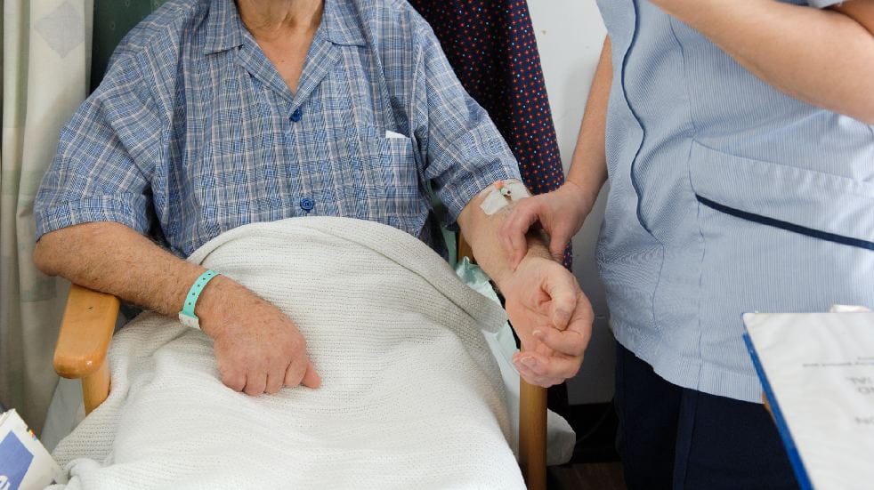 nurse taking patient's pulse